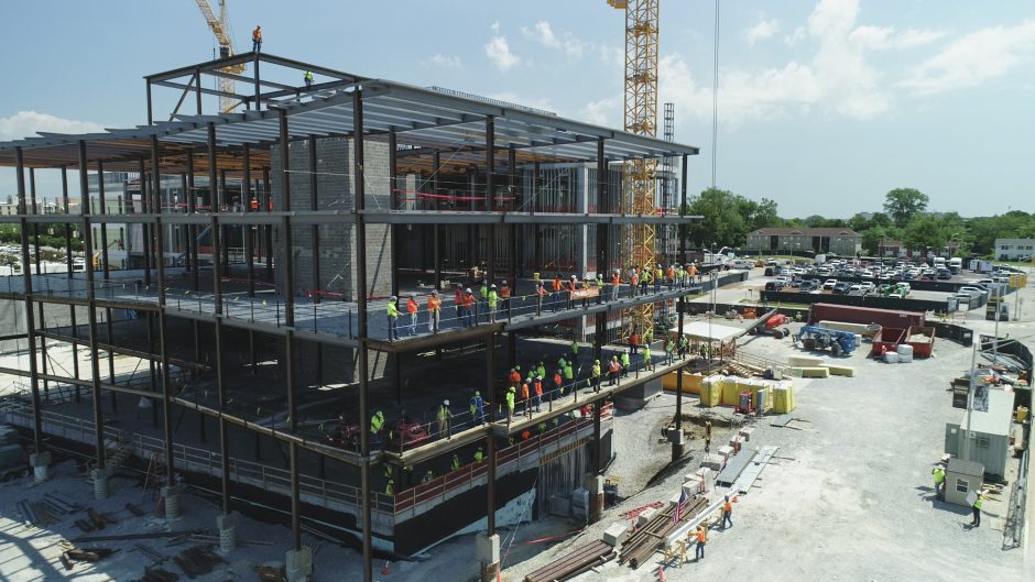 Construction specialists celebrate the topping off of the NextGen Precision Health Institute on June 18, 2020.