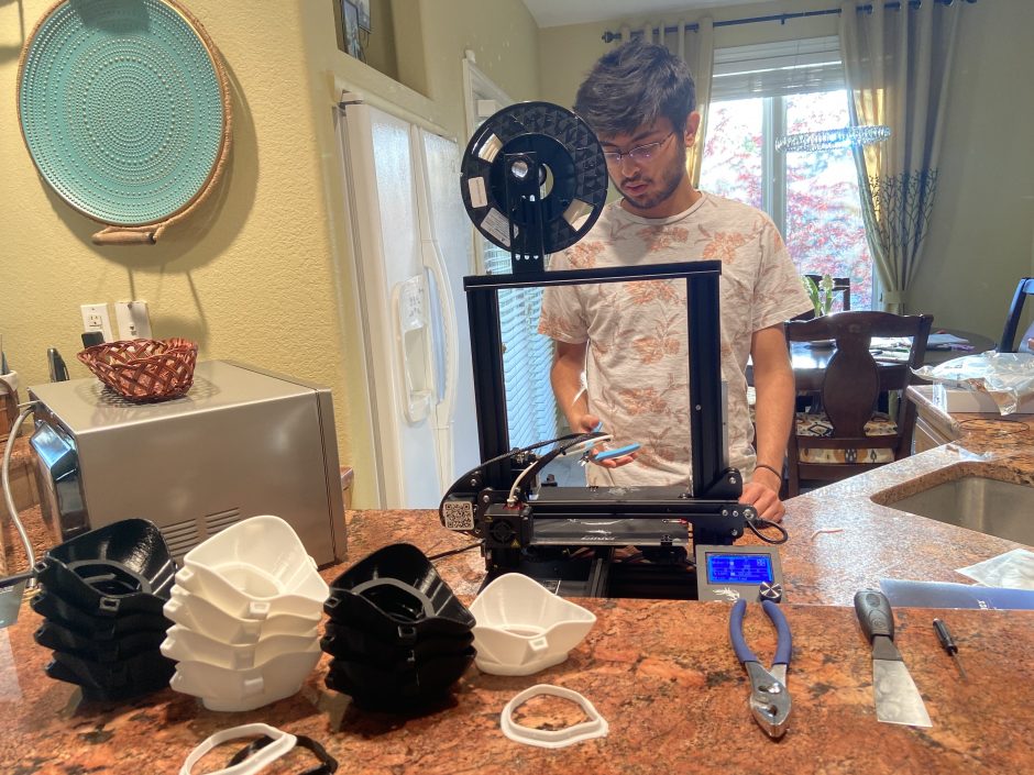This is an image of Ashul Soni using the 3D printer to make the masks.